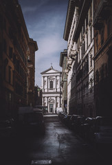narrow street with church in Rome Italy