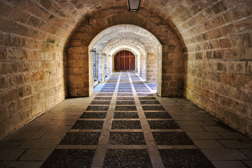 Obraz premium Palma cathedral ancient brick passageway with arches and iron gate, mallorca, spain.