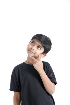 Cute Indian boy thinking idea and looking at up, isolated on white background 