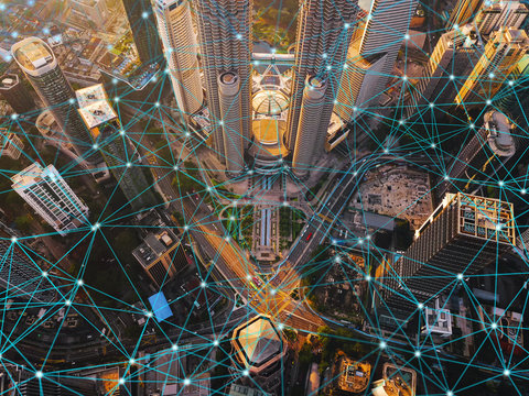 Digital network connection lines of Kuala Lumpur Downtown, Malaysia. Financial district and business centers in smart city in technology concept. Skyscraper and high-rise buildings at sunset