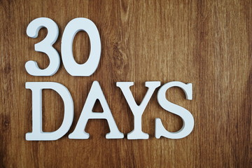 30 Days alphabet letter with space copy on wooden background