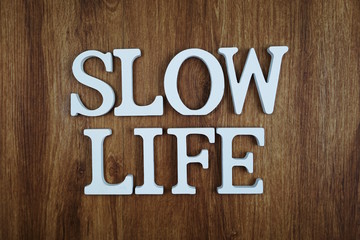 Slow Life alphabet letter with space copy on wooden background