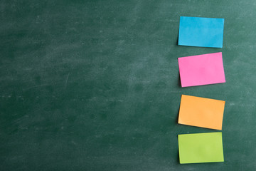 Colorful sticky notes on the blank blackboard