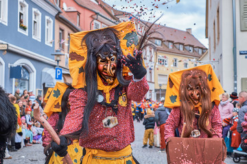Witch with big yellow hood. Street Carnival in Southern Germany - Black Forest.