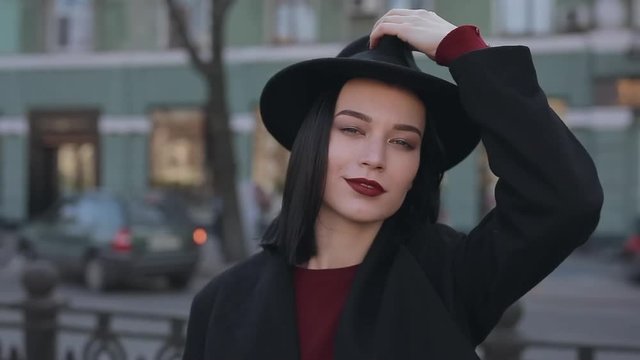 Portrait of stylish woman wearing fashion hat in urban city