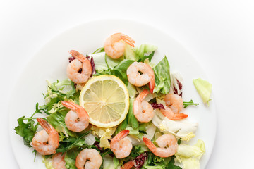 delicious shrimp with salad and lemon