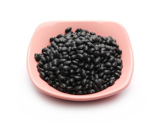 Black beans in bowl isolated on white background