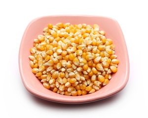 Corn kernels in bowl isolated on white background