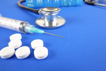 Medical Concept with stethoscope ,syringe  isolated on blue background. Copy Space