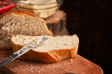 Bakery - gold rustic crusty loaves of bread and buns on black chalkboard background. Still life captured from above