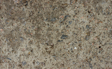 The texture of the old concrete wall with stones, cracks, dust, cracks, roughness. Texture, background