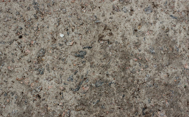 The texture of the old concrete wall with stones, cracks, dust, cracks, roughness. Texture, background