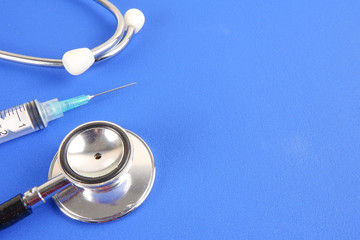 Medical Concept with stethoscope ,syringe  isolated on blue background. Copy Space