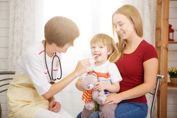 Beautiful mother and her little son at the reception at the doctor