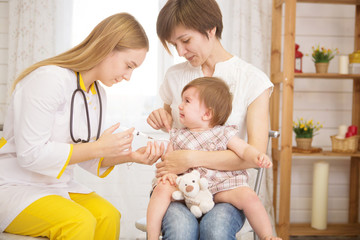 A doctor giving a crying child an injection at home