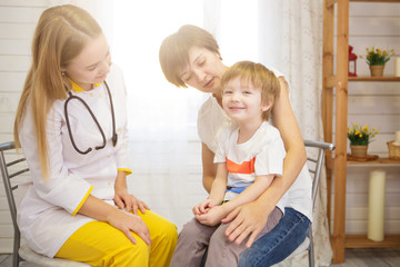 Pediatrist examinate young patient's lungs with stethoscope