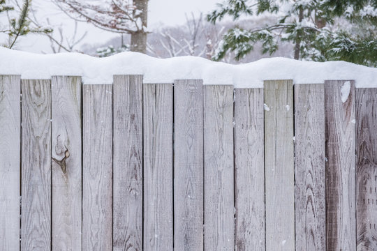 Wooden wall with snow top