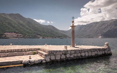 Pier on the island near the old church in Montenegro