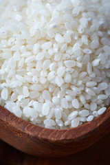 Raw uncooked sushi rice in wooden bowl. Concept for preparing sushi