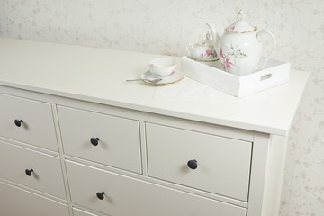 White tea service on white commode ready for use on tray.