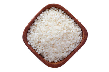 Raw uncooked sushi rice in wooden bowl isolated on white background