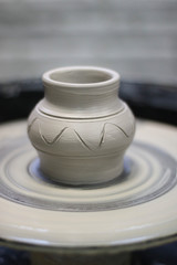 Clay vessel on the Potter's wheel in the pottery.