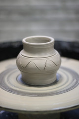 Clay vessel on the Potter's wheel in the pottery.