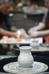 Clay vessel on the Potter's wheel in the pottery.