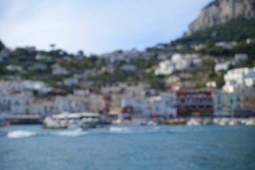 Naklejka na ściany i meble Blurry view of coastline port in Italy