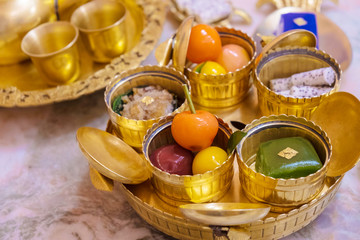 Thai desserts in golden cups served on golden platter
