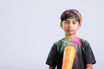 Indian Child playing holi with color gun