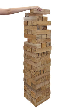 Hands playing large giant wooden tower game