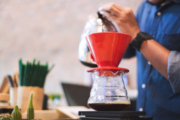 Barista pouring water on coffee filter