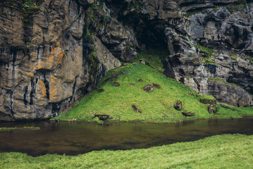 Fototapeta na wymiar Small river near Skogafoss waterfall in southern Iceland