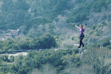 Womanbalancing on the rope concept of risk taking and challenge.