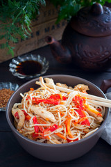 Rice noodles with chicken and vegetables, selective focus