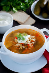 Rassolnik - Russian cuisine soup with pickles and barley, selective focus