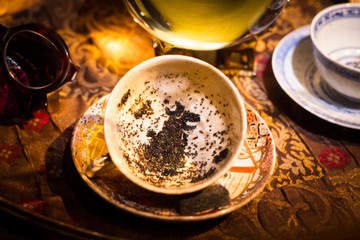  cup with black-shaped tea grounds