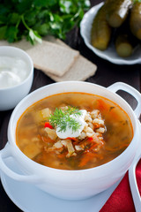 Rassolnik - Russian cuisine soup with pickles and barley, selective focus