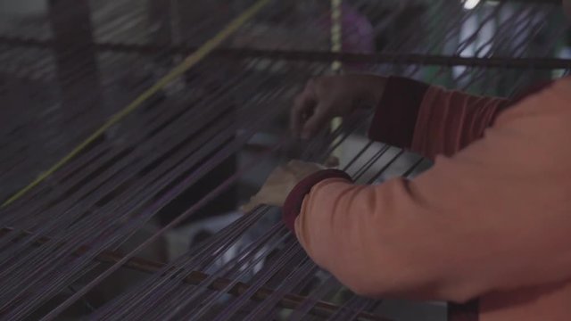 Woman weaving silk by hand