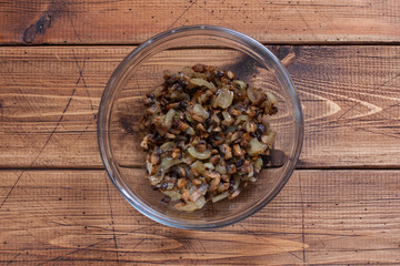 Step by step preparation of pork rolls with mushrooms - step 3 - preparation of the filling, roasting mushrooms with onions, top view, horizontal