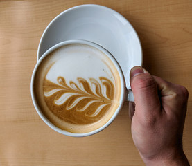 Hand holding mug of coffee