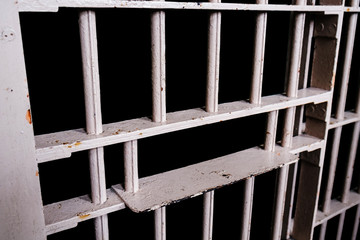 Food channel through prison cell's bars with clipping path