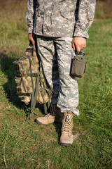 The soldier holds a flask