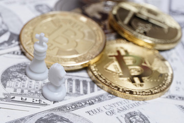 Chess pieces with bitcoins on US dollars background, conceptual photography, money game
