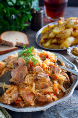 Cabbage stew with turkey meat in a metal dish, selective focus