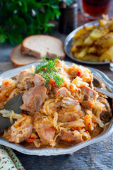 Cabbage stew with turkey meat in a metal dish, selective focus