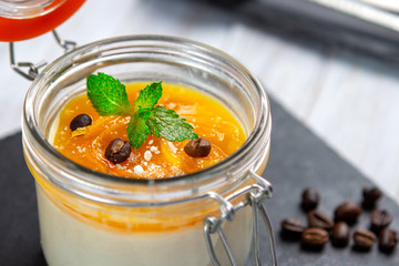 Orange Panna Cotta, traditional Italian dessert with a creamy pudding, close up