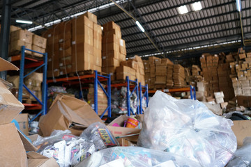Blurry image of poorly organized warehouse with a lot of messy stocks and boxes
