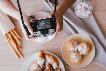 Food blogging hobby. Sweet homemade bakery assortment. Woman shooting fresh cakes and pastries from...